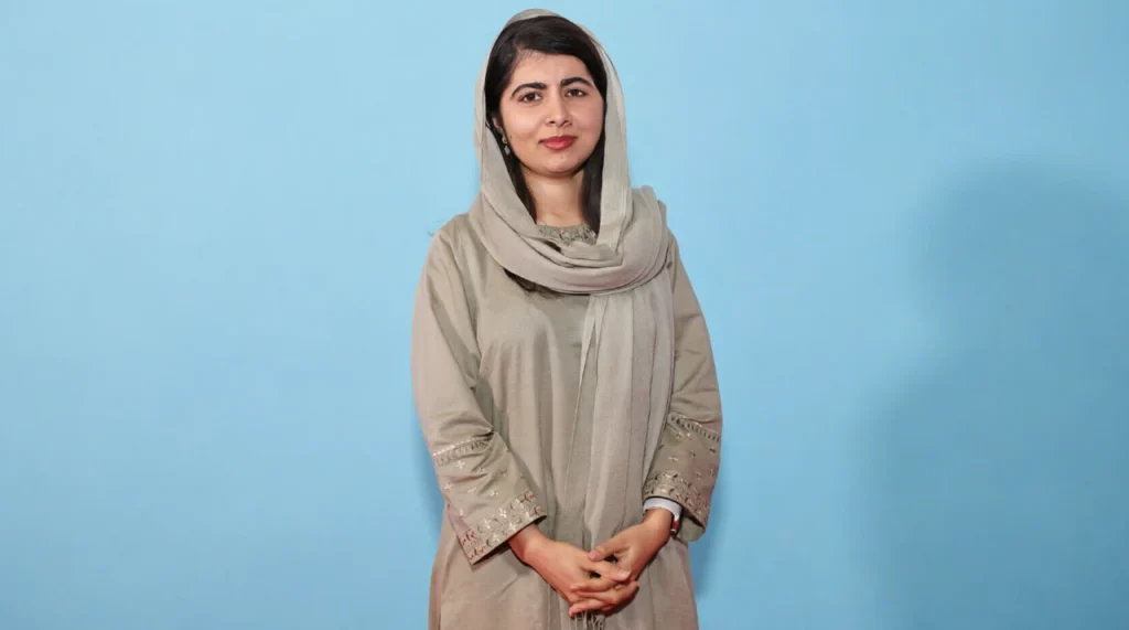 Malala Yousafzai in a headscarf, looking determined and calm.