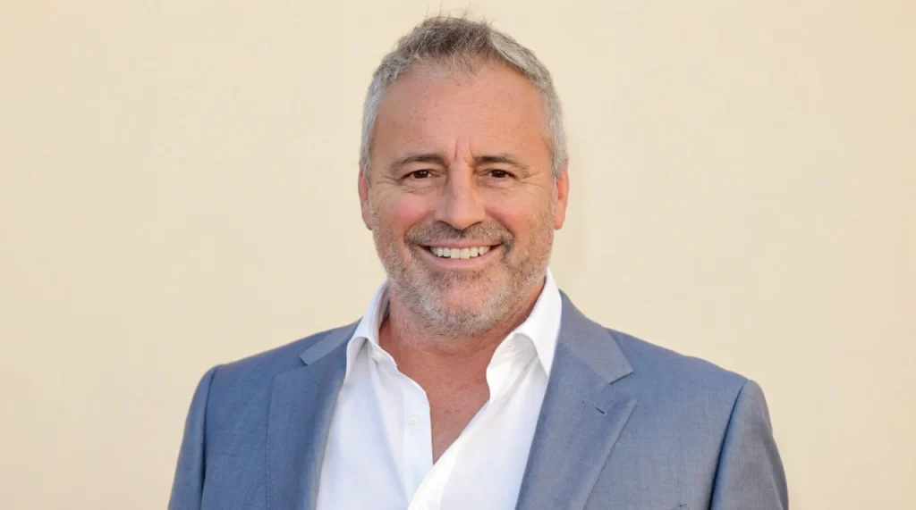 Matt LeBlanc grinning, salt-and-pepper hair, casual jacket.